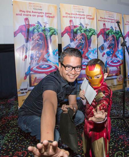 PLDT Vice President and Head of Home Voice Solutions Patrick Tang gets into character with a young superhero.