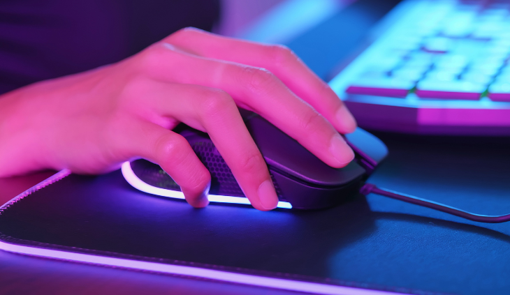 Closeup of hands using gaming mouse and mouse pad