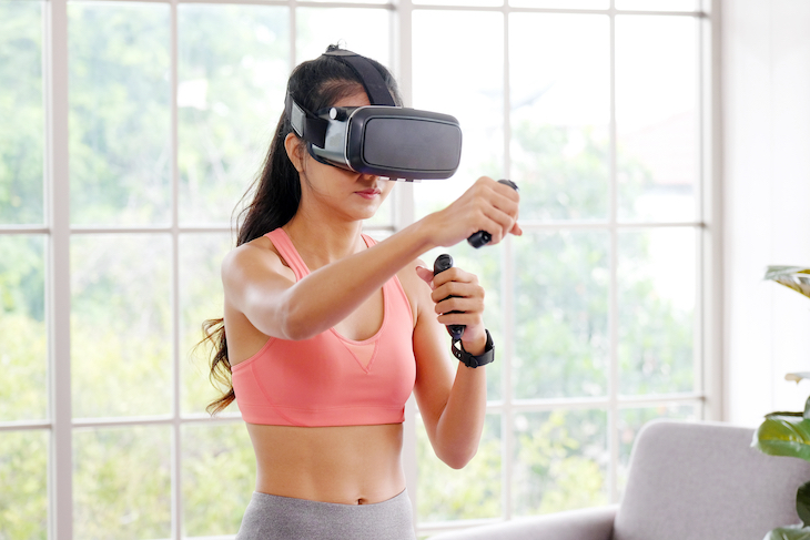 Girl wearing VR headset for fitness