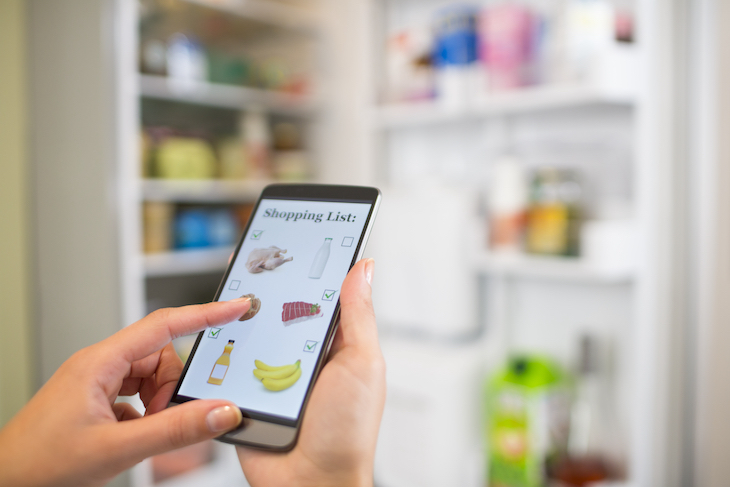 Making shopping list on phone connected to smart refrigerator