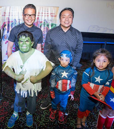PLDT Vice President and Head of Home Voice Solutions Patrick Tang (left) and PLDT Vice President and Head of Home Marketing Gary Dujali (right) with kids dressed up in their favorite Marvel superhero costumes